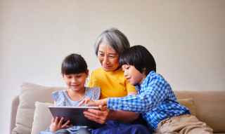 grandma and kids looking at a tablet