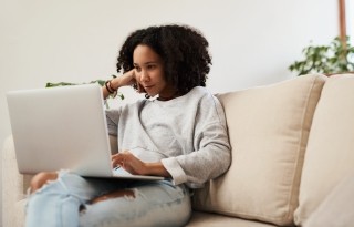 woman on couch with laptop