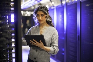 technology woman working on servers